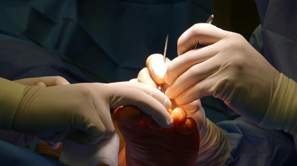 Podiatric Doc examining a patient's foot and ankle pain.